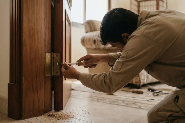 Damaged wooden door hinges and worn sofa fabric before repair, Al Nahda villa Sharjah